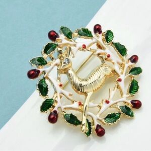 Elegant Gold Reindeer Brooch with Green and Red Accents
